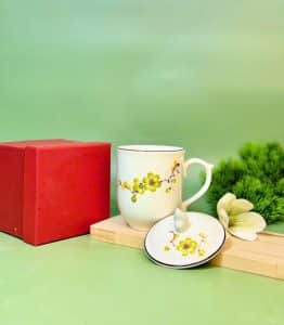 cốc in ấn logo hoa đào xanh men kem